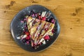 Top view of crepe with chocolate cream, chocolate chips, banana and strawberry served on grey plate Royalty Free Stock Photo