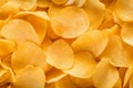 Top view of crispy appetizing yellow potato chips background Royalty Free Stock Photo