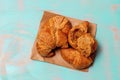 Top View Of Croissants On Brown Paper With Wooden Teal Green Rustic Background With Space For Text
