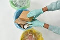 Top view of cropped black girl sorting garbage