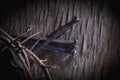 Top view of crown of thorns and nails again vintage wooden background as symbol of crucifixion of Jesus Christ Royalty Free Stock Photo