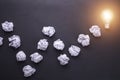 Top view crumpled paper and light bulbs on black stone board. Cr Royalty Free Stock Photo