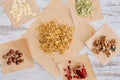 Crunchy granola ingredients on baking parchment pieces
