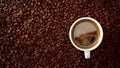 Top view of cup of black coffe put it on coffe beans background Royalty Free Stock Photo