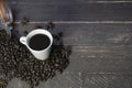 Top view of a cup of black coffee with coffee beans on wooden table.Coffee vintage wood background with big copy space for text Royalty Free Stock Photo