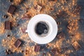 Top view cup of black coffee on a dark stone background with beans, cocoa powder and chocolate pieces scattered around. Selective Royalty Free Stock Photo