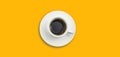 Top view cup of black coffee on a bright yellow background using for banner design. Royalty Free Stock Photo