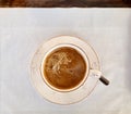 Top view of a cup of Cafe Crema on a white doily Royalty Free Stock Photo
