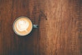 Top view cup of cappuccino on wooden table with beautiful latte art. Copy space Royalty Free Stock Photo