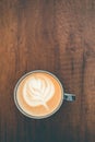 Top view cup of cappuccino on wooden table with beautiful latte art. Copy space Royalty Free Stock Photo