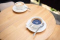 Top view cup of coffee americano and cappuccino on a wooden table, in the summer terrace of a cafeteria. Food and drink