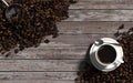 Top view of cup of coffee and coffee beans over the vintage wood background Royalty Free Stock Photo