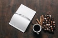 Top view. Cup of coffee with chocolate candies and a Notepad on wooden background. Work and relax space concept