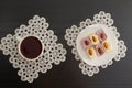 Top view of a cup of coffee and colorful Turkish Delight with almonds on the lace napkins black table Royalty Free Stock Photo