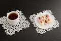 Top view of a cup of coffee and colorful Turkish Delight with almonds on the lace napkins black table Royalty Free Stock Photo