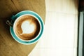 Top view. cup with coffee has a heart shape on top both placed o Royalty Free Stock Photo