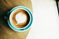 Top view. cup with coffee has a heart shape on top both placed o Royalty Free Stock Photo