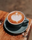 Close Up Of A Coffee Machine Pouring A Processed Coffee Into A MugTop View of a cup of coffee latte on a brown cafe table.