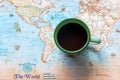 Top view of cup coffee one the word map for Traveler accessories and items man with backpack and visiting for planning travel vaca Royalty Free Stock Photo