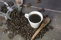 Top view of a cup of coffee and roasted coffee beans in glass jar on rustic wooden table Royalty Free Stock Photo