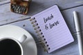 Top view of a cup of coffee,vintage toy typewriter,pen and notebook written with Lunch and Learn on wooden background Royalty Free Stock Photo