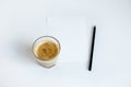top view of cup of coffee on white paper with pencil Royalty Free Stock Photo