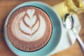 Top view cup of hot chocolate art on saucer with spoon and tea. Royalty Free Stock Photo