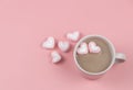 A cup of hot chocolate with  heart shape marshmallows on pink background with copy space. Valentine`s day and beverage concept Royalty Free Stock Photo