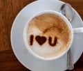 Top view of a cup of hot coffee cappuccino, latte decorated with heart art I love you message Royalty Free Stock Photo