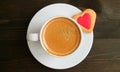 Top View of a Cup of Hot Coffee with Heart Shaped Cookie on Dark Brown Wooden Table Royalty Free Stock Photo