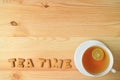 Top View of a Cup of Hot Lime Tea and Cookies Spelling the Word TEA TIME on Wooden Table with Copy Space Royalty Free Stock Photo