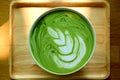 Top View of a Cup of Hot Matcha Green Tea Latte on Natural Wooden Tray Royalty Free Stock Photo