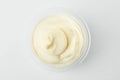 Top view on a cup of mayonnaise on white background