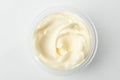 Top view on a cup of mayonnaise on white background