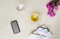 Top view cup of tea with flower , cell phone, glass of water and Royalty Free Stock Photo