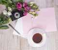 Top view of cup of tea, flowers, vintage camera, earphones, pen Royalty Free Stock Photo