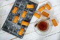 Top view of cup of tea with homemade financier cakes