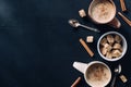 top view of cups of coffee, spoons, bowl of cane sugar and cinnamon stick Royalty Free Stock Photo
