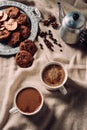 top view of cups of fresh coffee with chocolate chip cookies and vintage metal pot Royalty Free Stock Photo