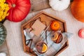 Top view cups with hot spiced tea with star anise, cinnamon stick, slice of orange on the wooden tray with decorative