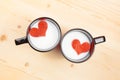 Top of view of cups of milk with decorative heart on wood table, concept of valentine day