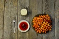 Top view of curd waffles on a plate, apricot jam, a glass of milk and a fork on a wooden table Royalty Free Stock Photo