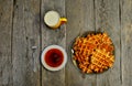 Top view of curd waffles on a plate, apricot jam, a mug of milk and a fork on an old wooden table Royalty Free Stock Photo