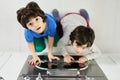 Top view of curious little latin boys, twins looking at camera while sitting in the kitchen and watching pie baking in Royalty Free Stock Photo