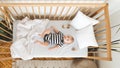 Curious newborn baby lying in crib and looking at camera