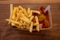 Currywurst, grilled pork sausage on top with curry powder served with curry ketchup sauce and Fried potatoes. Royalty Free Stock Photo