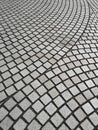 Top view, curve pattern of grey cobblestones paving on a street