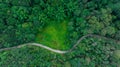 top view of curved road in green forest in the rain season, rural routes connecting city in the north of thailand, Ecosystem and