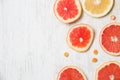 Top view on cut red and yellow grapefruit. Fresh organic citrus on white wooden background. Healthy snack dessert Royalty Free Stock Photo