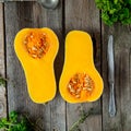 Top view Cut ripe orange pumkin with seeds on the rustic wooden table. Vegetarian, vegan, healthy diet food. Autumn harvest concep Royalty Free Stock Photo